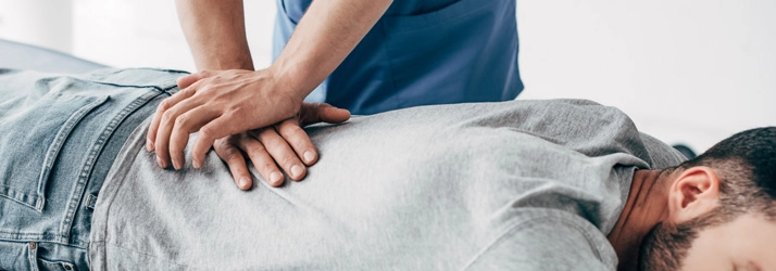 A patient receiving a lower back adjustment.