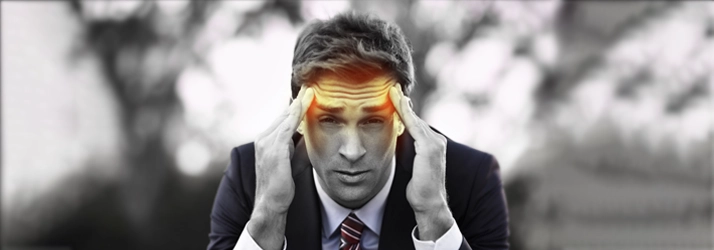 Chiropractic Fremont CA Headache Man A man holding he head. It is highlighted orange.
