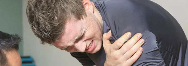 Chiropractic Fremont CA Shoulder Pain A person holding their shoulder in pain.