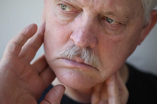 Chiropractic Fremont CA TMJ Man A man holding his jaw.